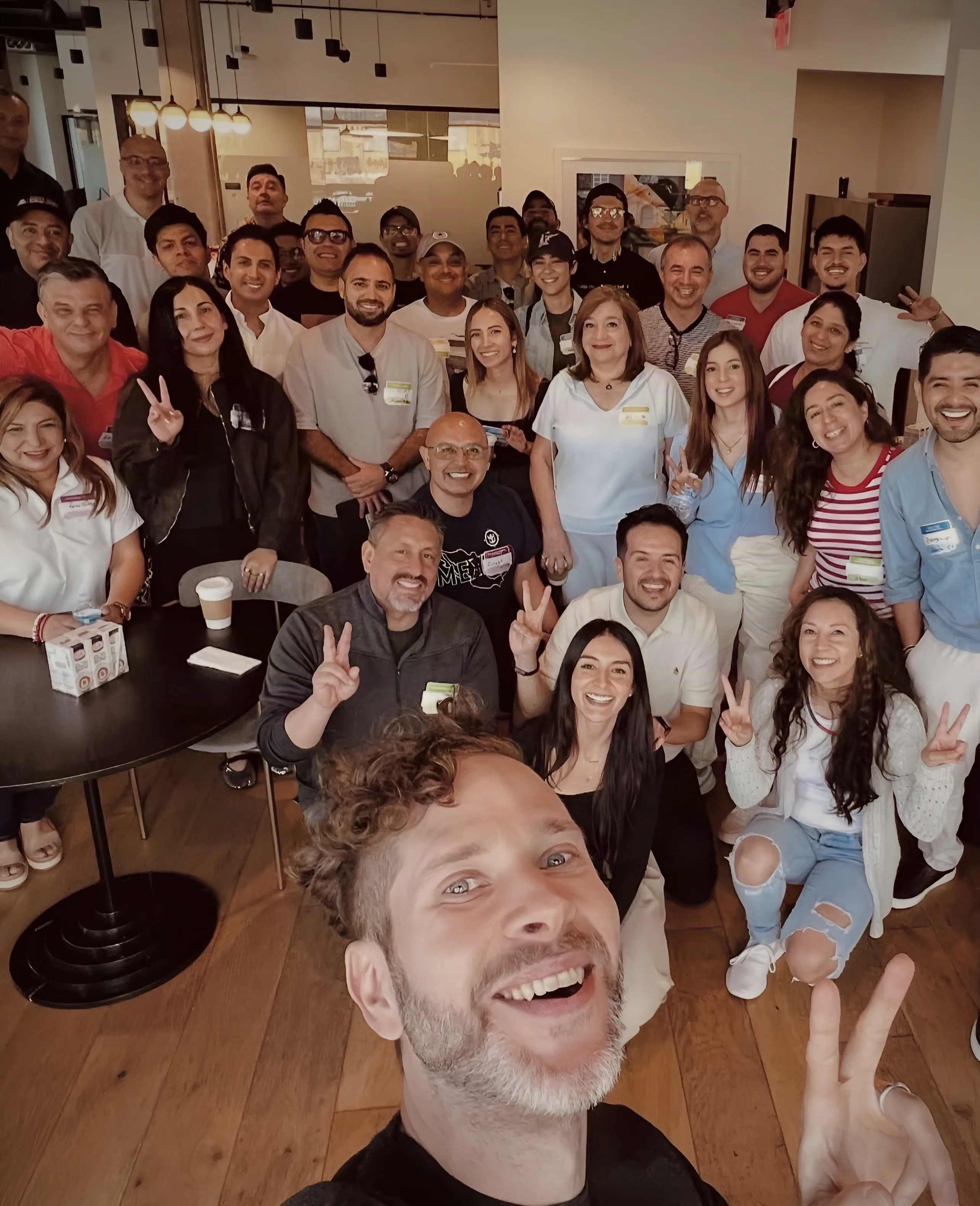 Cafecito Tech community gathered for a group selfie
